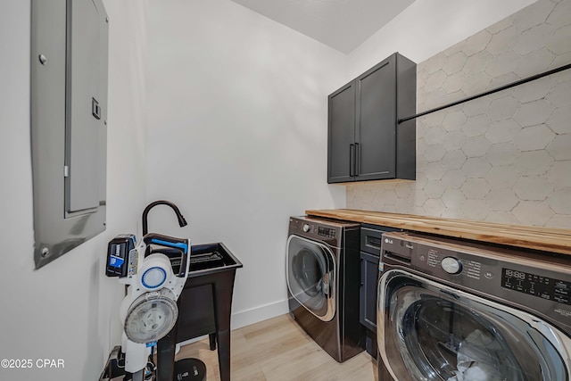 7603 Coastal Hammock Trl, Panama City Beach, FL 32413 - clothes washing area featuring independent washer and dryer, cabinet space, light wood-type flooring, and baseboards