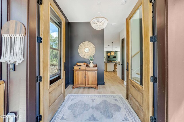 7603 Coastal Hammock Trl, Panama City Beach, FL 32413 - entryway with a chandelier and light wood-type flooring