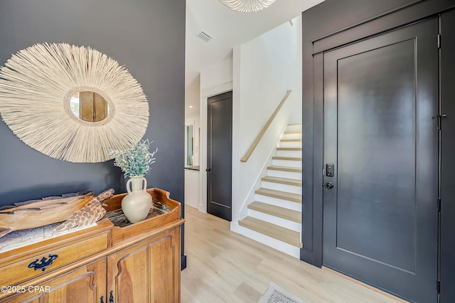 7603 Coastal Hammock Trl, Panama City Beach, FL 32413 - entrance foyer with stairway and light wood-style flooring