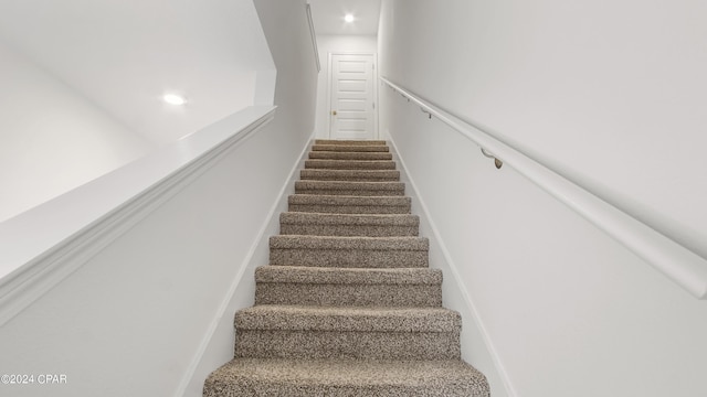 stairs featuring recessed lighting