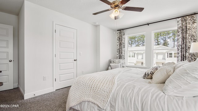 bedroom with ceiling fan, baseboards, and carpet