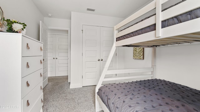 bedroom with a closet, carpet, and visible vents