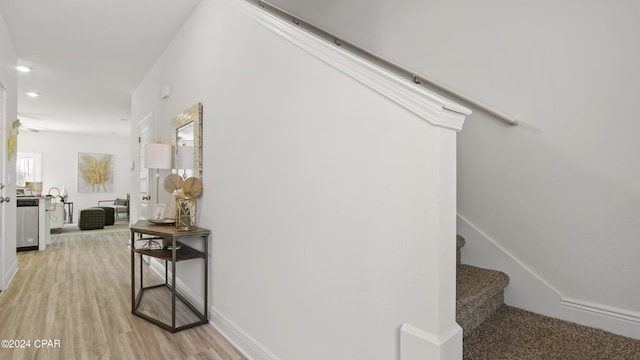 stairway featuring recessed lighting, wood finished floors, and baseboards