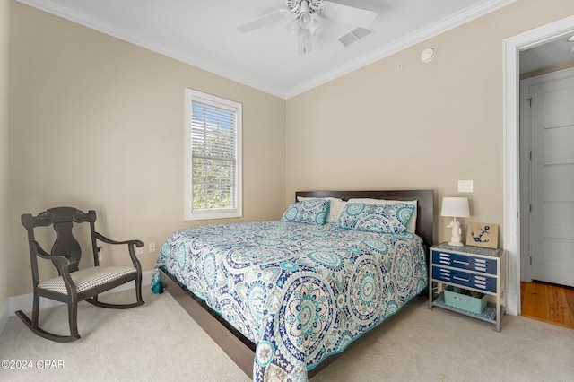 carpeted bedroom featuring crown molding, visible vents, baseboards, and ceiling fan