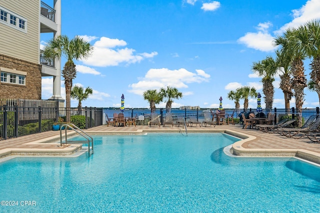 pool featuring a patio area and fence