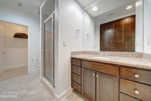 8700 Front Beach Rd Unit 5101, Panama City Beach, FL 32407 - bathroom with a stall shower, a walk in closet, vanity, baseboards, and recessed lighting