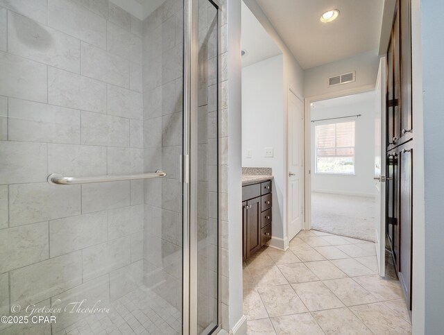 8700 Front Beach Rd Unit 5101, Panama City Beach, FL 32407 - full bathroom featuring vanity, a shower stall, tile patterned flooring, and baseboards