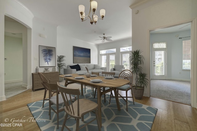 8700 Front Beach Rd Unit 5101, Panama City Beach, FL 32407 - dining space with a ceiling fan, a chandelier, baseboards, and light wood-type flooring