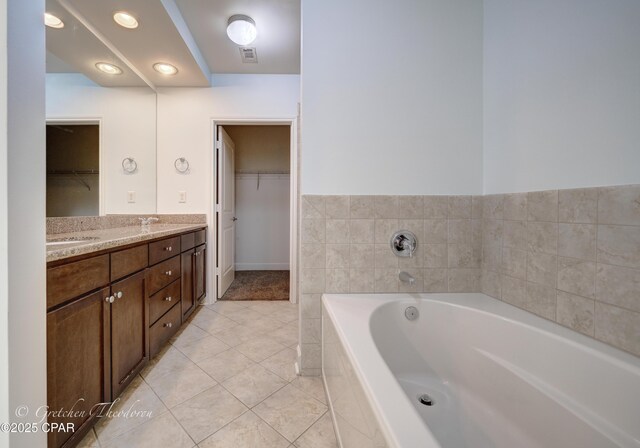 8700 Front Beach Rd Unit 5101, Panama City Beach, FL 32407 - full bathroom featuring tile patterned flooring, a walk in closet, a bath, and double vanity