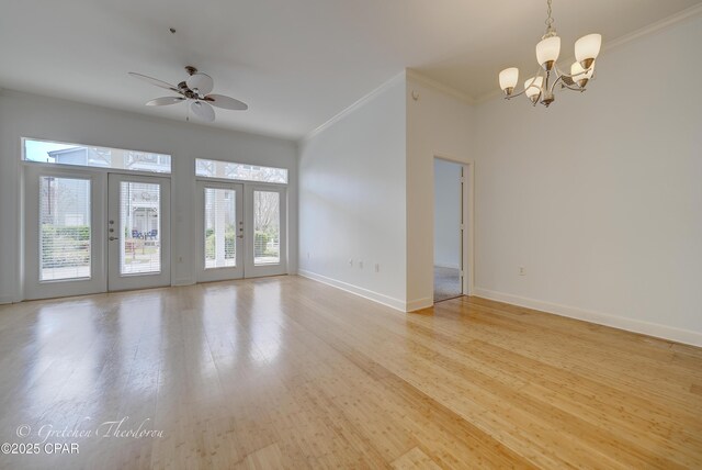 8700 Front Beach Rd Unit 5101, Panama City Beach, FL 32407 - unfurnished room with ornamental molding, baseboards, a chandelier, a ceiling fan, and light wood-style flooring
