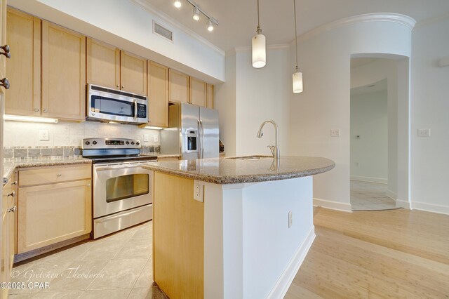 8700 Front Beach Rd Unit 5101, Panama City Beach, FL 32407 - kitchen with appliances with stainless steel finishes, light brown cabinets, a sink, crown molding, and light stone countertops