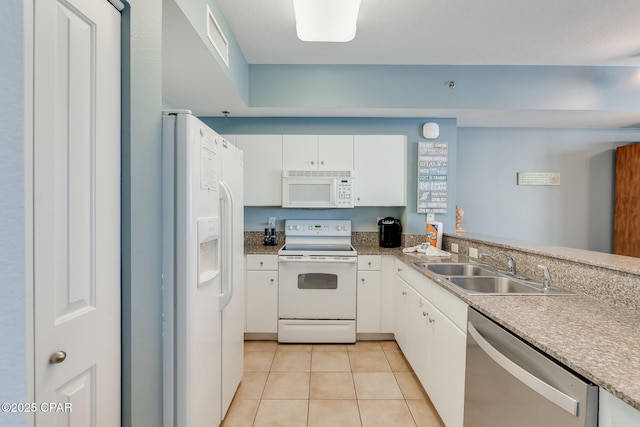 kitchen featuring a sink, light tile patterned floors, white appliances, visible vents, and white cabinets