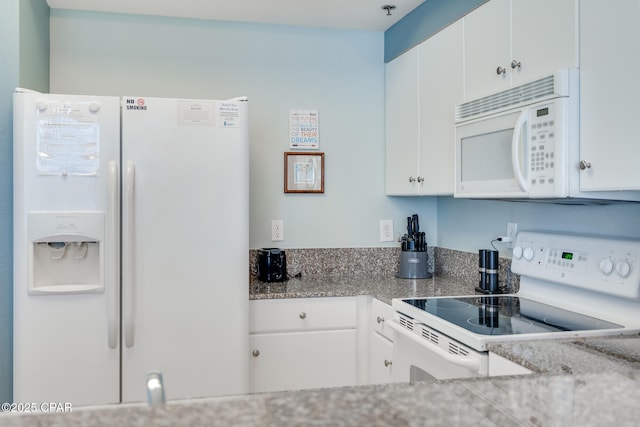 kitchen featuring white appliances, white cabinets, and light stone counters