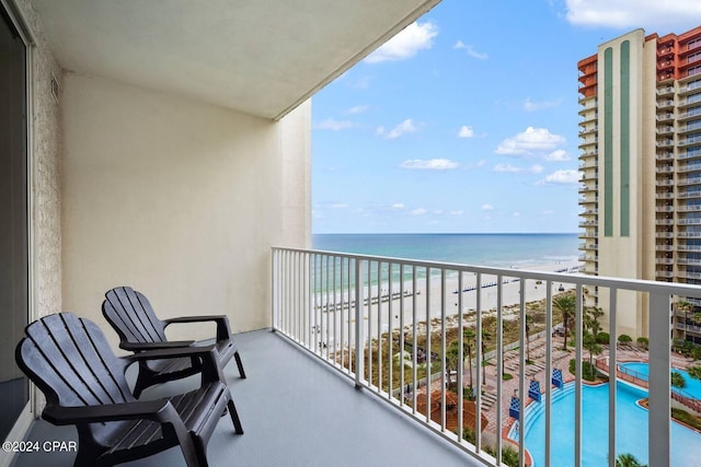 balcony with a water view and a beach view