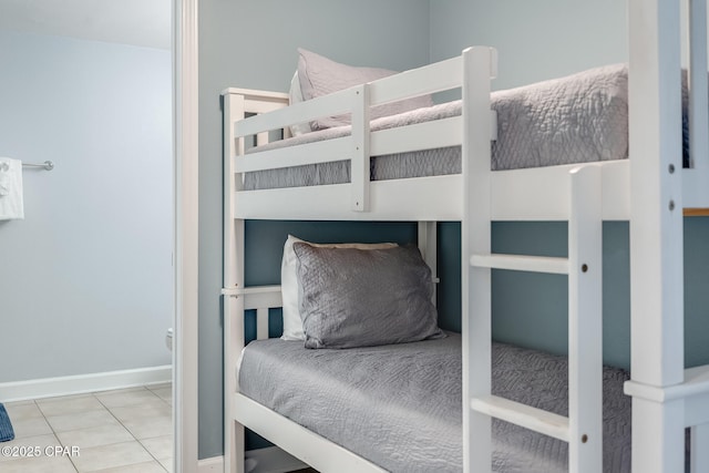 bedroom featuring tile patterned flooring and baseboards