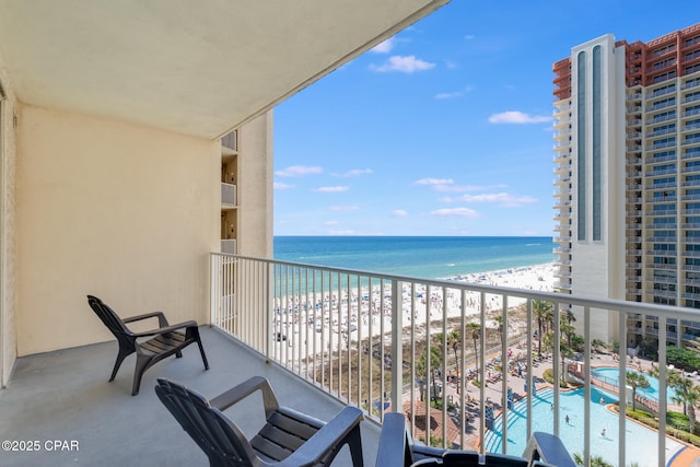 balcony featuring a water view and a view of the beach