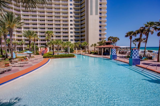view of swimming pool with a water view and a gazebo
