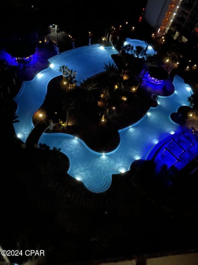 pool at night featuring heating fuel
