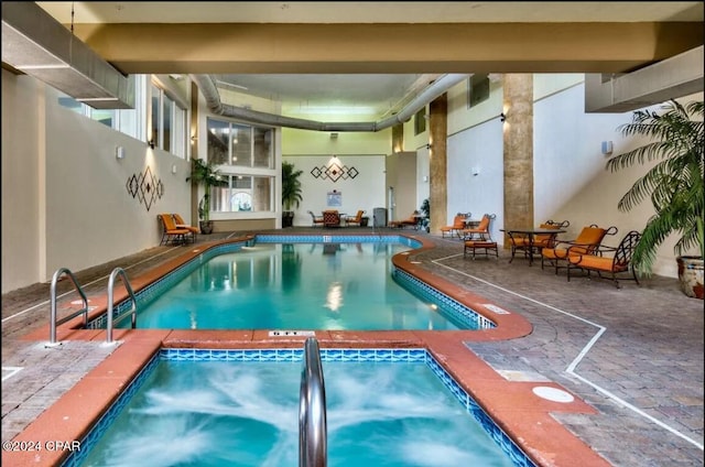 pool with an indoor in ground hot tub
