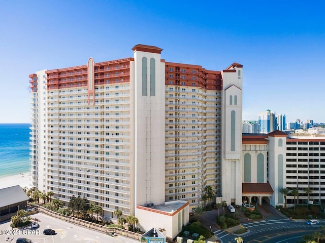 view of building exterior with a water view and a city view