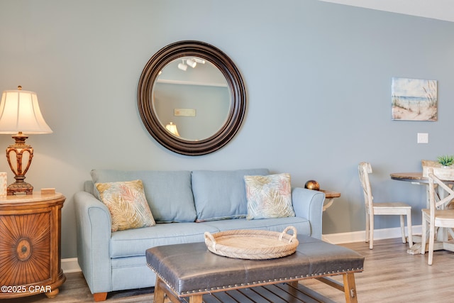 living room with baseboards and wood finished floors