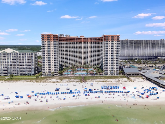 view of property featuring a water view and a beach view