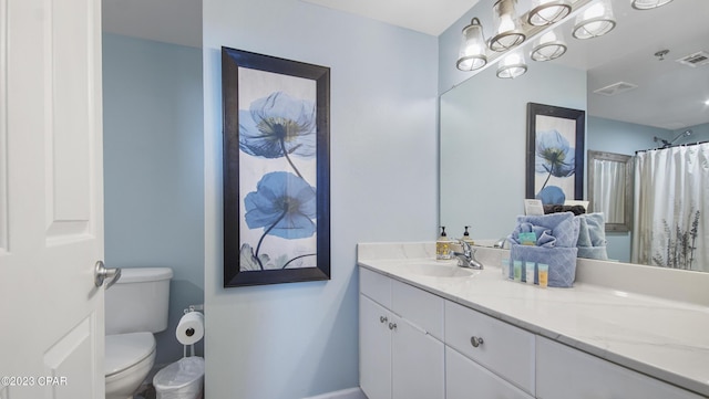 bathroom featuring visible vents, toilet, and vanity