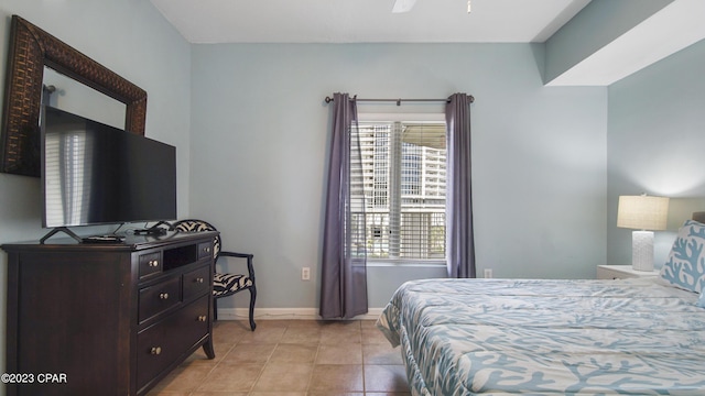 bedroom with baseboards and light tile patterned flooring