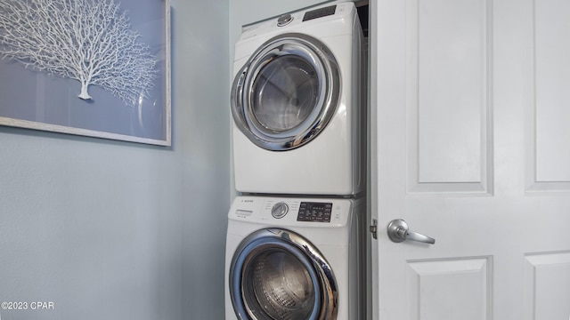 laundry area featuring stacked washer and dryer and laundry area