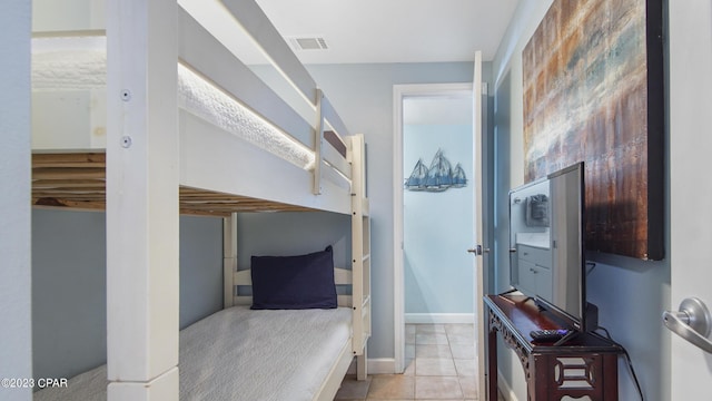 bedroom with light tile patterned flooring, baseboards, and visible vents