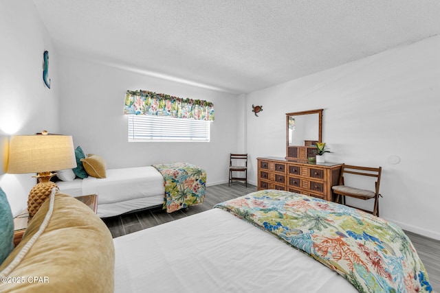 5801 Thomas Dr Unit 1216, Panama City Beach, FL 32408 - bedroom with baseboards, wood finished floors, and a textured ceiling