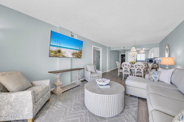 5801 Thomas Dr Unit 1216, Panama City Beach, FL 32408 - living area with a textured ceiling, visible vents, and baseboards