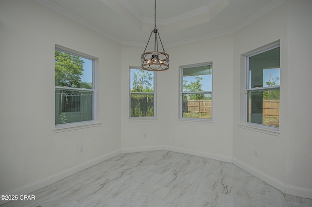 2613 Shadow Ridge Ct, Lynn Haven, FL 32444 - spare room with marble finish floor, an inviting chandelier, a tray ceiling, and plenty of natural light