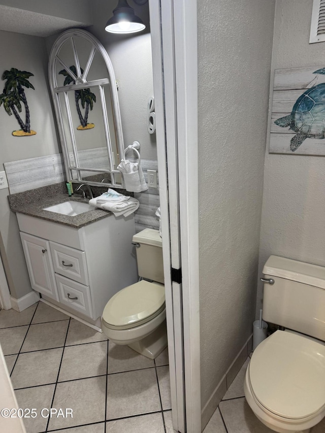 8743 Thomas Dr Unit 1328, Panama City, FL 32408 - bathroom featuring toilet, tile patterned flooring, and vanity