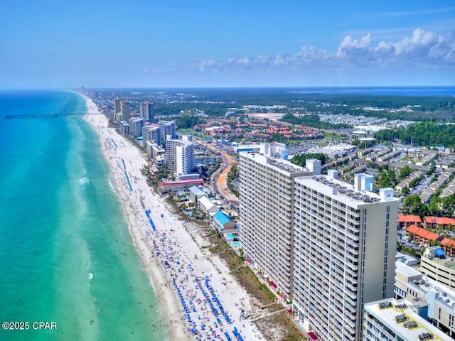 drone / aerial view with a water view, a view of city, and a beach view