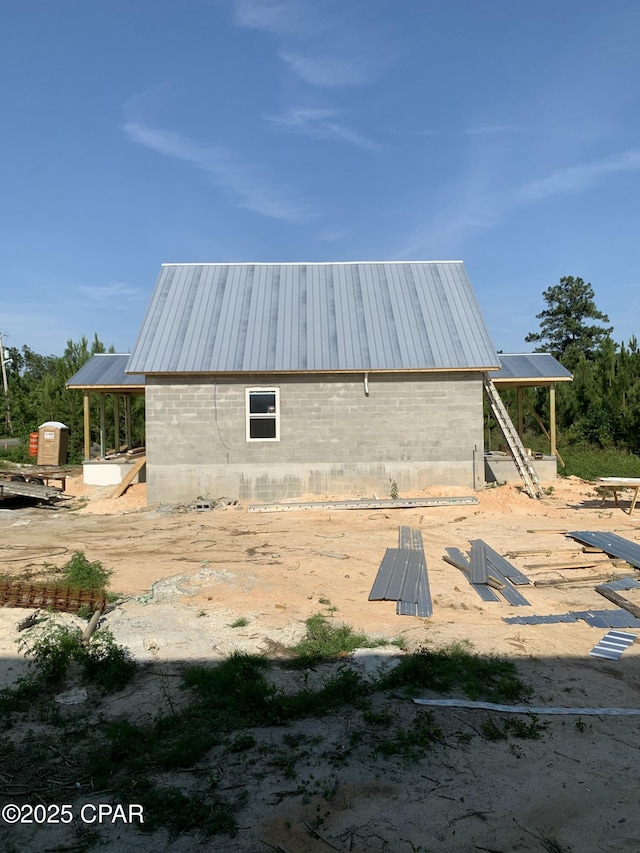 view of side of property featuring metal roof
