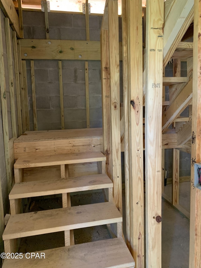 stairs with concrete flooring