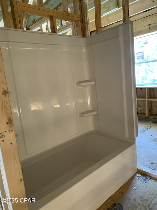 bathroom with washtub / shower combination