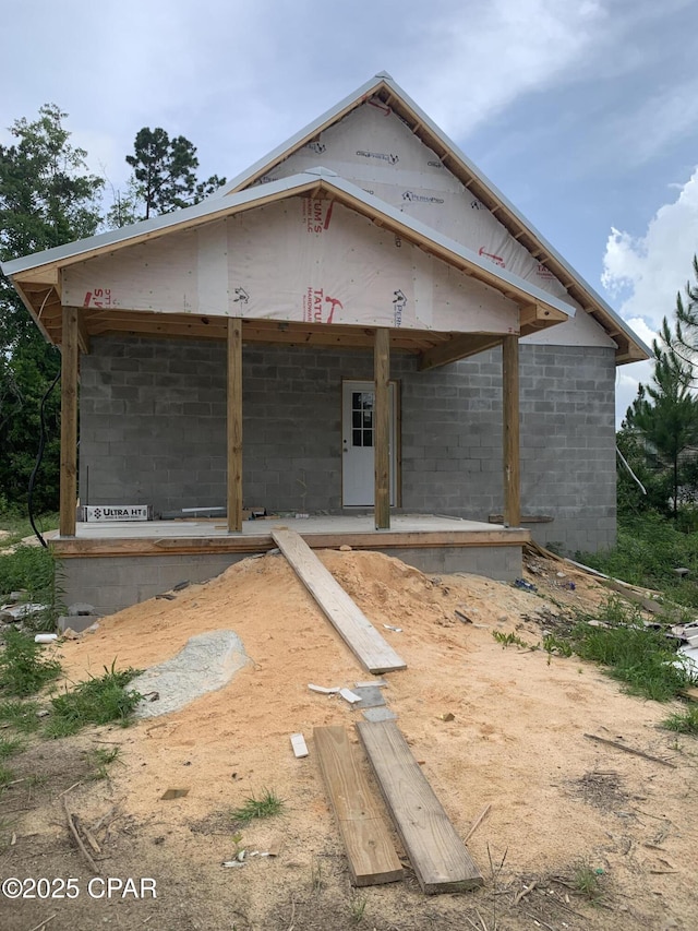 property under construction with concrete block siding