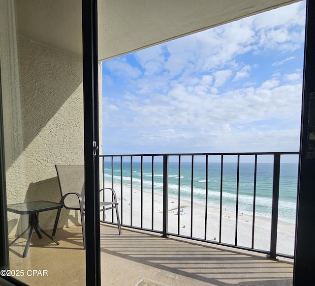 balcony featuring view of water and beach