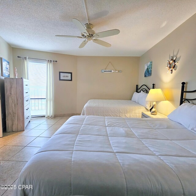 bedroom with tile patterned flooring, a textured ceiling, and ceiling fan