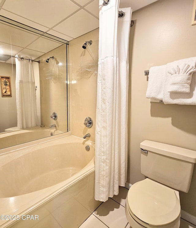 full bath featuring shower / bathtub combination with curtain, tile patterned flooring, baseboards, toilet, and a drop ceiling