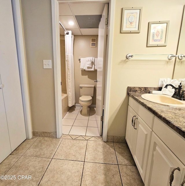 full bathroom featuring toilet, vanity, tile patterned floors, and baseboards