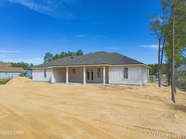 1709 White Western Lake Ln, Panama City, FL 32409 - rear view of property with french doors, a patio area, and roof with shingles