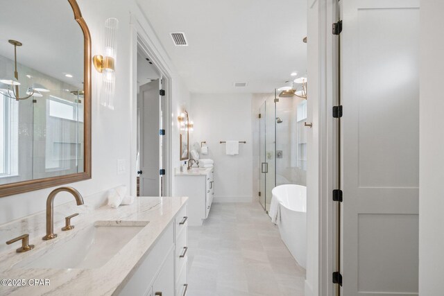 1709 White Western Lake Ln, Panama City, FL 32409 - full bathroom with a stall shower, two vanities, a freestanding tub, and tile patterned floors
