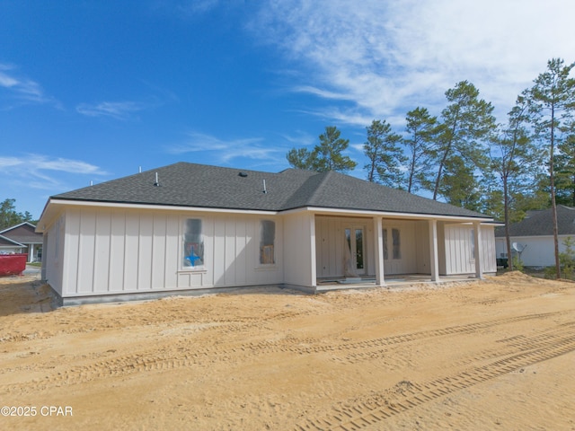 1709 White Western Lake Ln, Panama City, FL 32409 - rear view of property with a shingled roof and board and batten siding