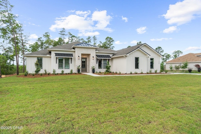 1709 White Western Lake Ln, Panama City, FL 32409 - prairie-style house with a front lawn, board and batten siding, and a shingled roof