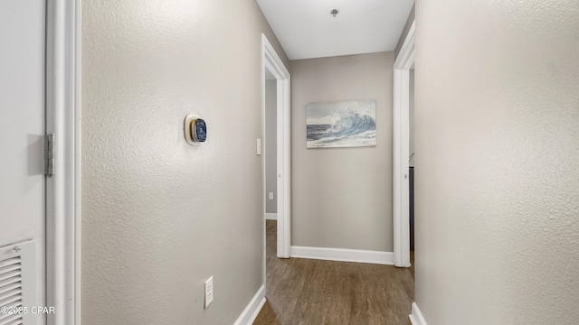 9900 S Thomas Dr Unit 1719, Panama City Beach, FL 32408 - hallway with dark wood-type flooring and baseboards