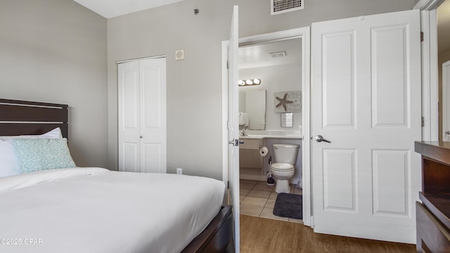 9900 S Thomas Dr Unit 1719, Panama City Beach, FL 32408 - bedroom with a closet, wood finished floors, and connected bathroom