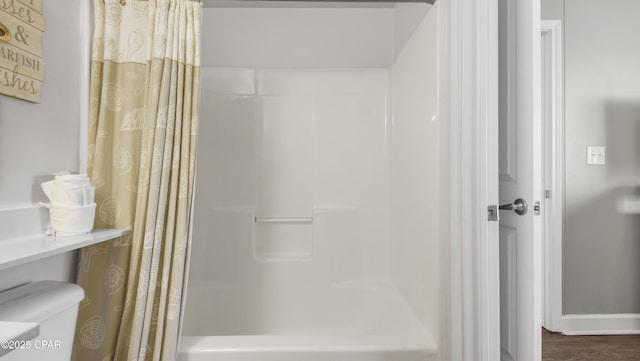 9900 S Thomas Dr Unit 1719, Panama City Beach, FL 32408 - bathroom featuring shower / tub combo and wood finished floors